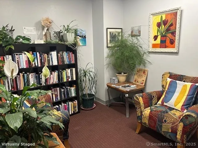 a living room with furniture and a book shelf