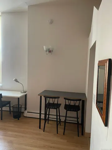 a view of a room with furniture and wooden floor