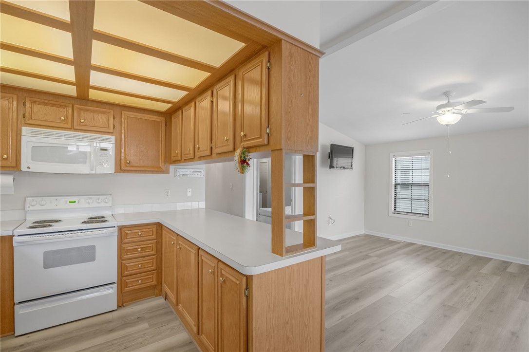 1230 Melton Road, Unit 25 West Union, SC 29696 - Photo 4 of 46 A well-equipped kitchen transitions seamlessly into a living space, featuring resilient flooring.