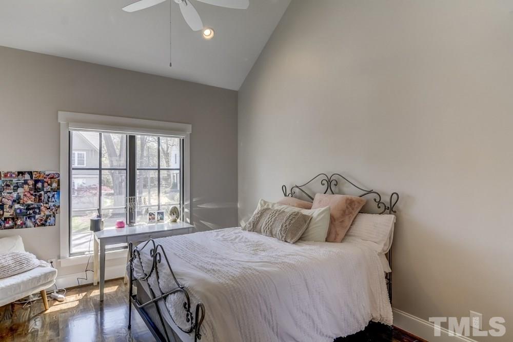 503 Peebles Street Raleigh, NC 27608 - Photo 22 of 30 a bedroom with a bed and a table