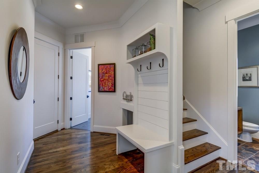 503 Peebles Street Raleigh, NC 27608 - Photo 8 of 30 a view of entryway with stairs and wooden floor