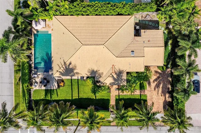 an aerial view of a house with a yard and potted plants