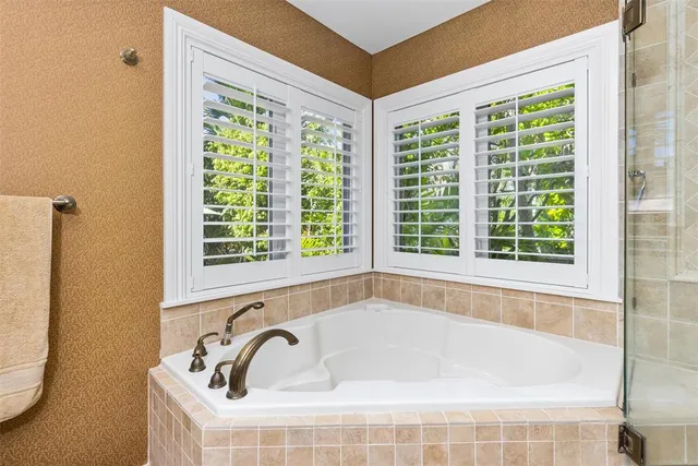 a bathroom with bathtub and window