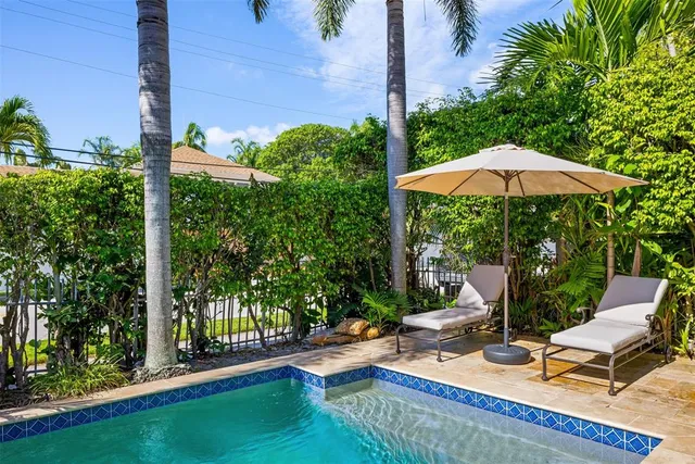 a view of a patio with chairs under an umbrella