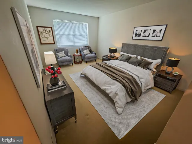 a bed room with a bed a couch and a window