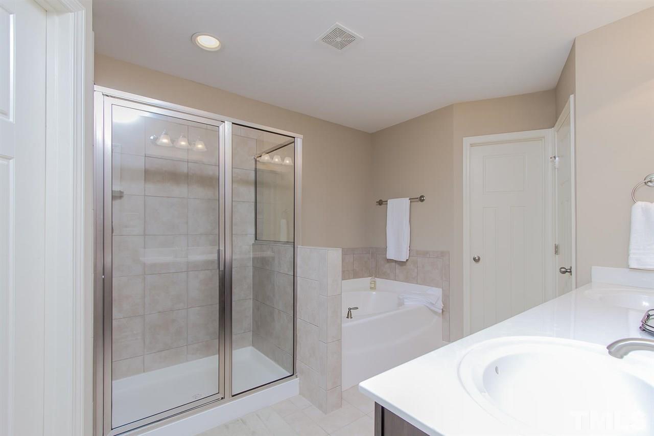 1401 Ranchester Road Knightdale, NC 27545 - Photo 16 of 24 Spa like master bathroom is sure to impress! Tile, garden tub, separate shower, huge walk in closets.