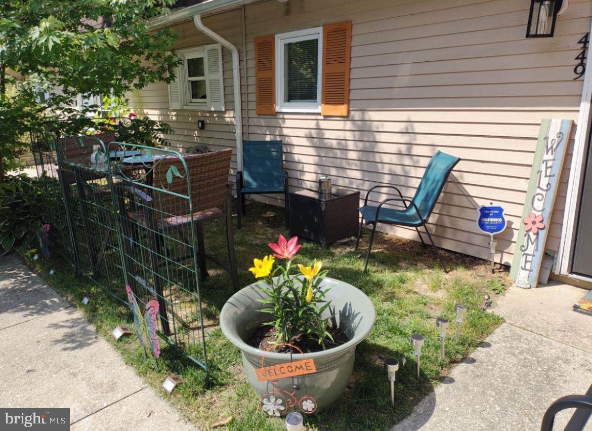 449 Via Cascata Drive Clementon, NJ 08021 - Photo 2 of 16 a view of a chair and table in backyard