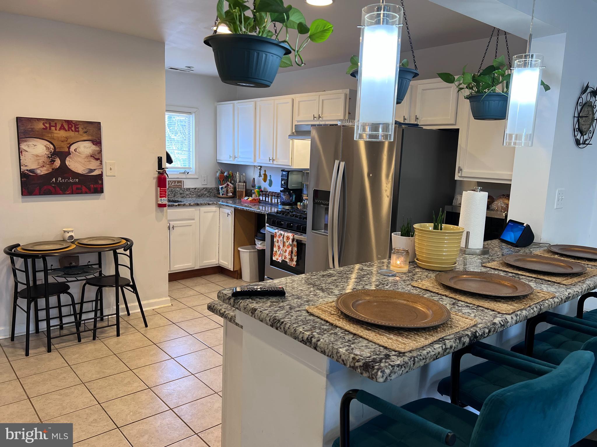 449 Via Cascata Drive Clementon, NJ 08021 - Photo 3 of 16 a kitchen with a table chairs and a refrigerator