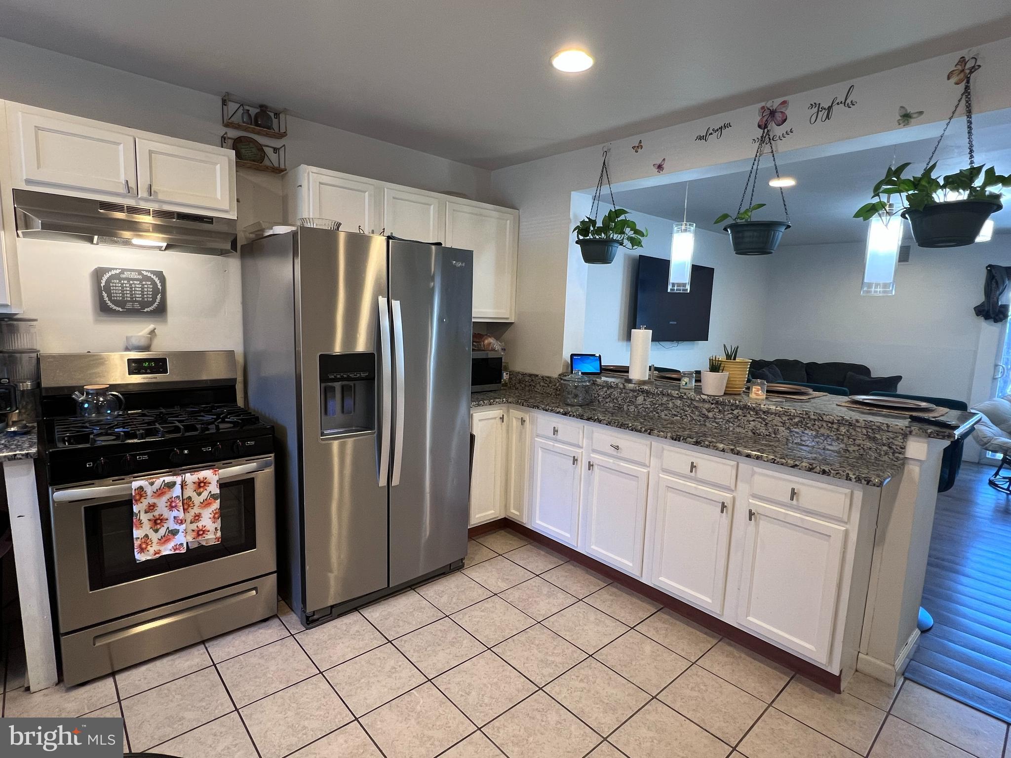 449 Via Cascata Drive Clementon, NJ 08021 - Photo 4 of 16 a kitchen with stainless steel appliances granite countertop a refrigerator a stove a sink and dishwasher