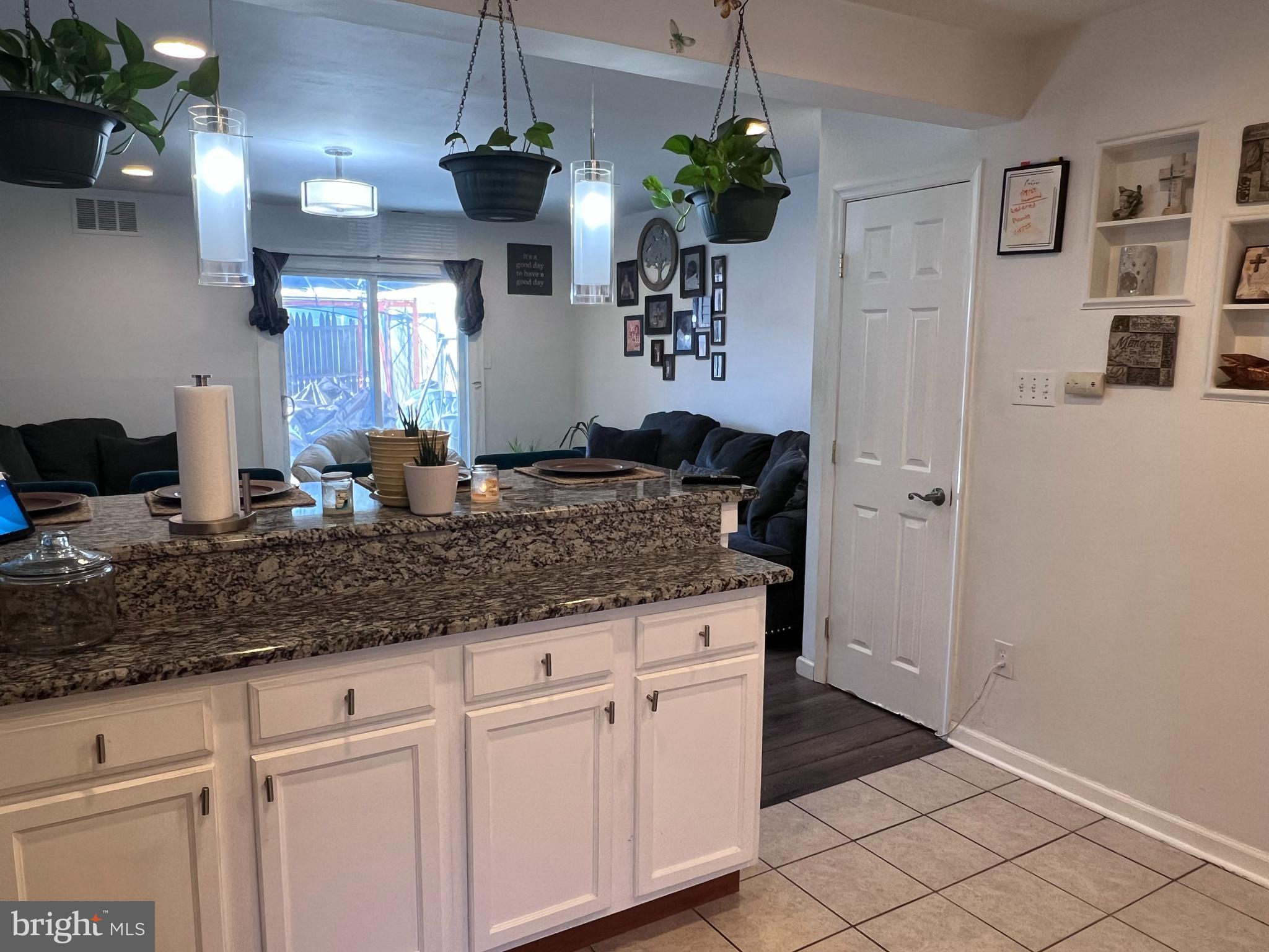449 Via Cascata Drive Clementon, NJ 08021 - Photo 5 of 16 a view of living room with granite countertop furniture and a chandelier