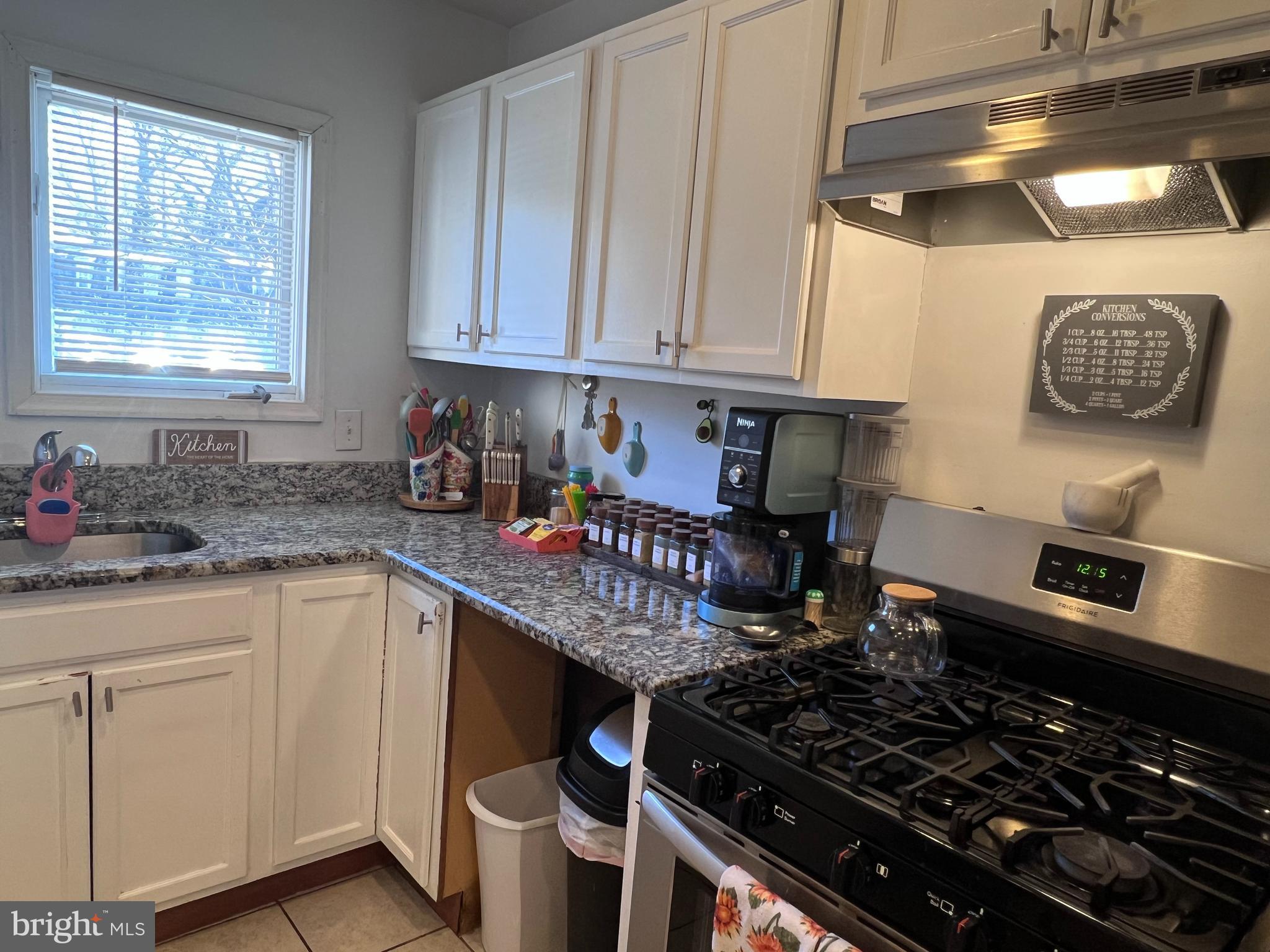 449 Via Cascata Drive Clementon, NJ 08021 - Photo 6 of 16 a kitchen with sink a stove and cabinets