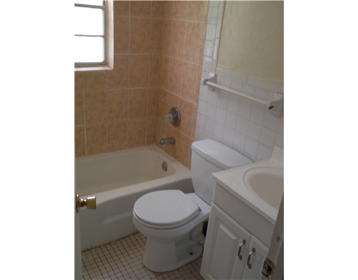 1176 West 32nd Street Riviera Beach, FL 33404 - Photo 7 of 10 a bathroom with a toilet and a bathtub