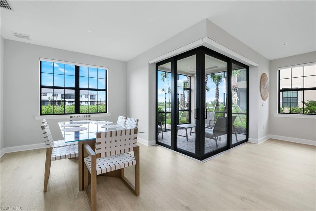 15336 Lucerna Street, Unit 104 Naples, FL 34114 - Photo 6 of 17 a view of a dining room with furniture and window