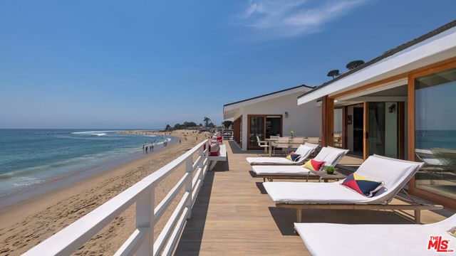 an entryway with furniture and painting on the wall