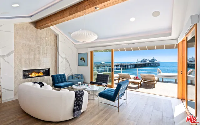 a living room with furniture and a floor to ceiling window