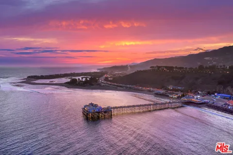 a balcony with table and chairs