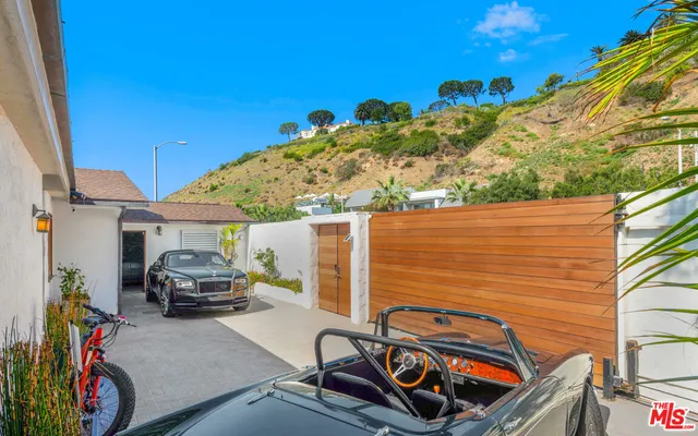 a front view of a house with plants