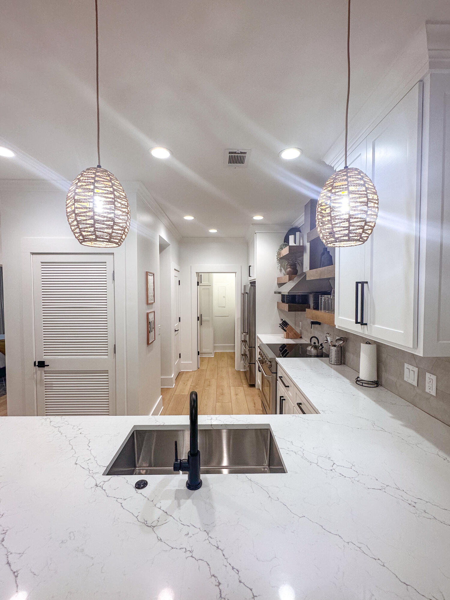 48 Rue Du Soleil Santa Rosa Beach, FL 32459 - Photo 13 of 37 a large kitchen with a chandelier stainless steel appliances a stove and a chandelier