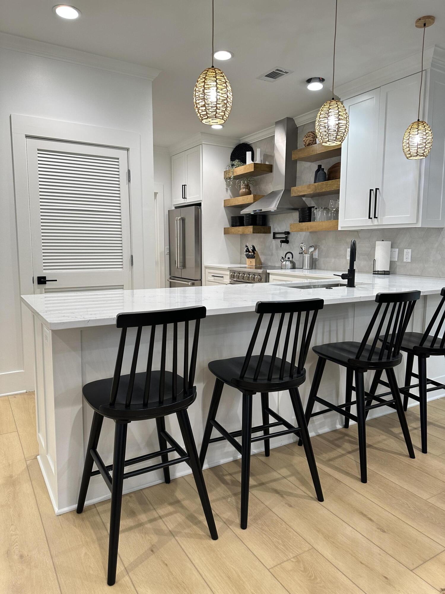 48 Rue Du Soleil Santa Rosa Beach, FL 32459 - Photo 19 of 37 a view of a dining room with furniture a chandelier and wooden floor