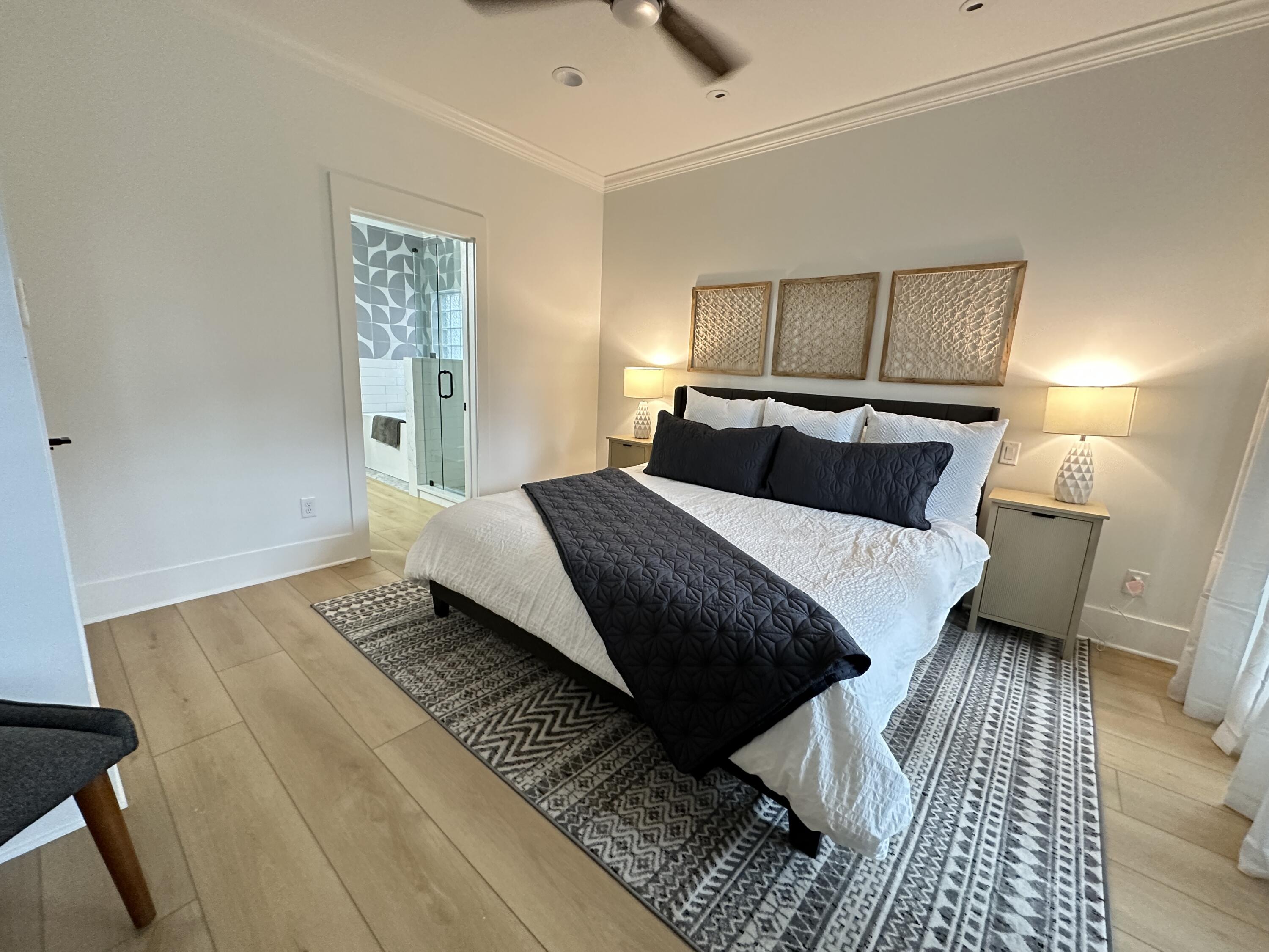 48 Rue Du Soleil Santa Rosa Beach, FL 32459 - Photo 27 of 37 a bedroom with a bed and wooden floor