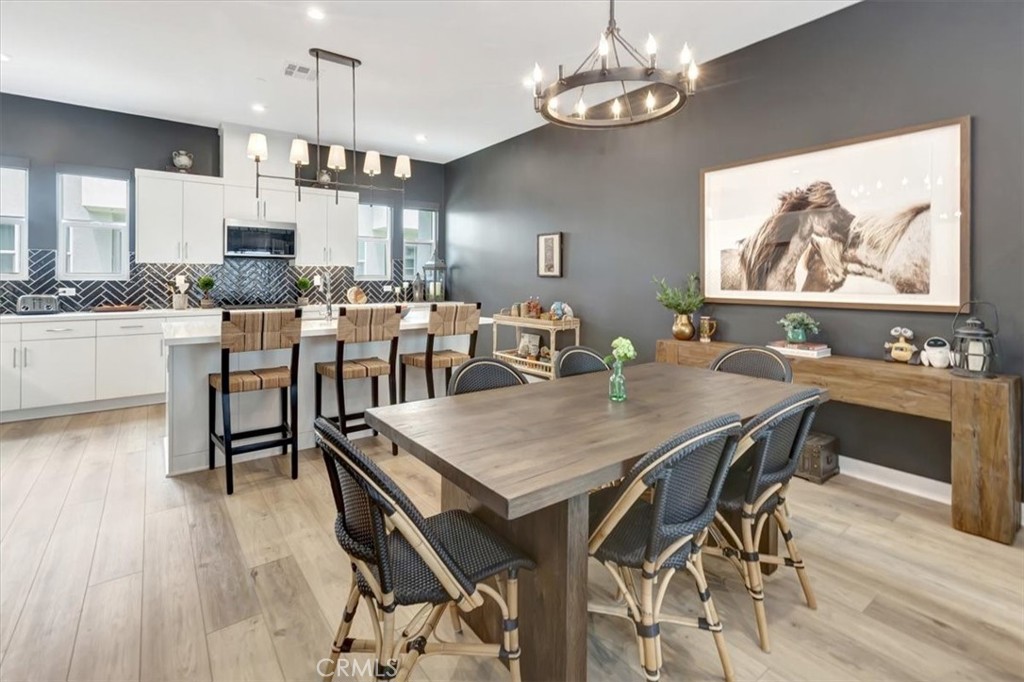 1810 West Bushell Street Anaheim, CA 92805 - Photo 10 of 36 a view of a dining room with furniture wooden floor and chandelier