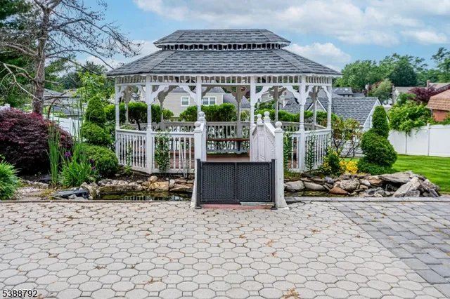 a view of a house with a big yard and large trees