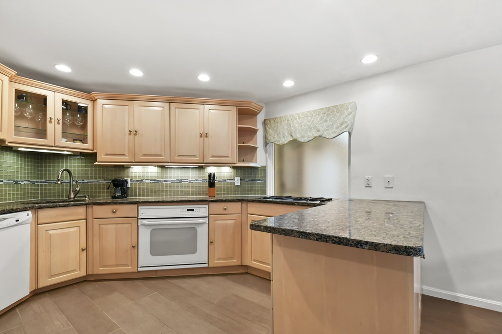 64 Mountain Gate Road, Unit 64 Ashland, MA 01721 - Photo 11 of 31 a kitchen with stainless steel appliances granite countertop a stove and a sink