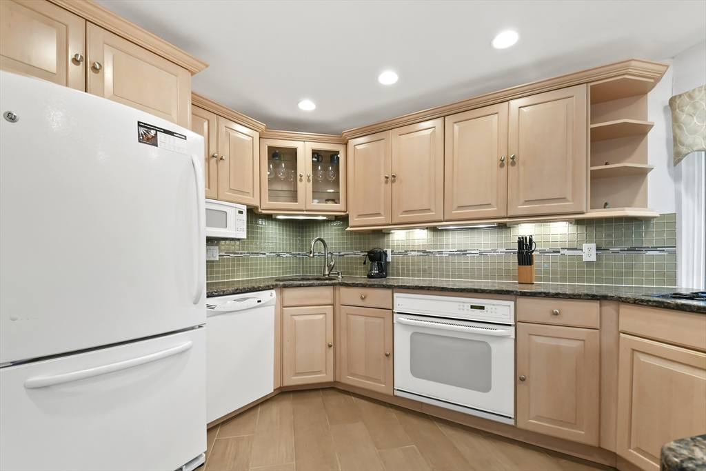64 Mountain Gate Road, Unit 64 Ashland, MA 01721 - Photo 12 of 31 a kitchen with stainless steel appliances granite countertop a sink and cabinets