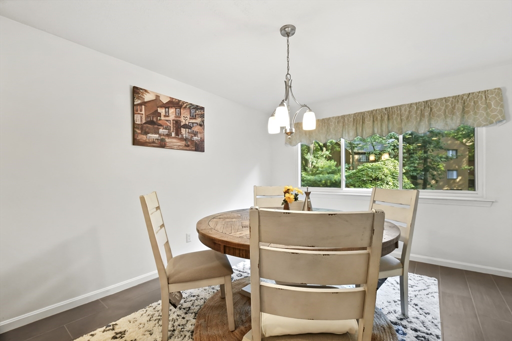 64 Mountain Gate Road, Unit 64 Ashland, MA 01721 - Photo 13 of 31 a view of a dining room with furniture window and outside view