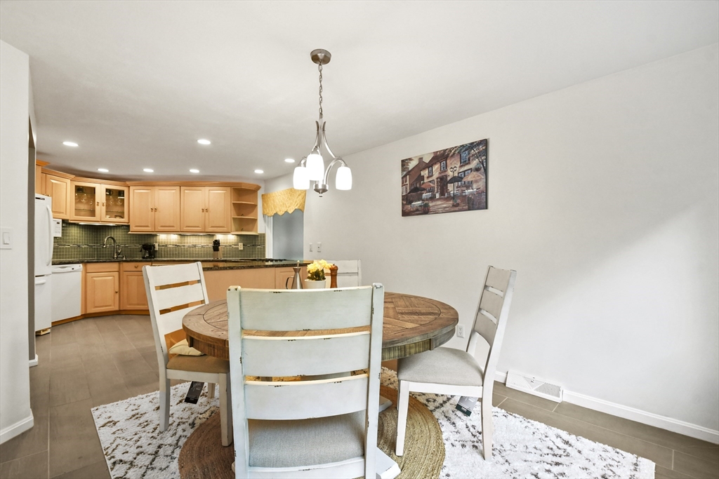 64 Mountain Gate Road, Unit 64 Ashland, MA 01721 - Photo 14 of 31 a view of kitchen with dining table and chairs