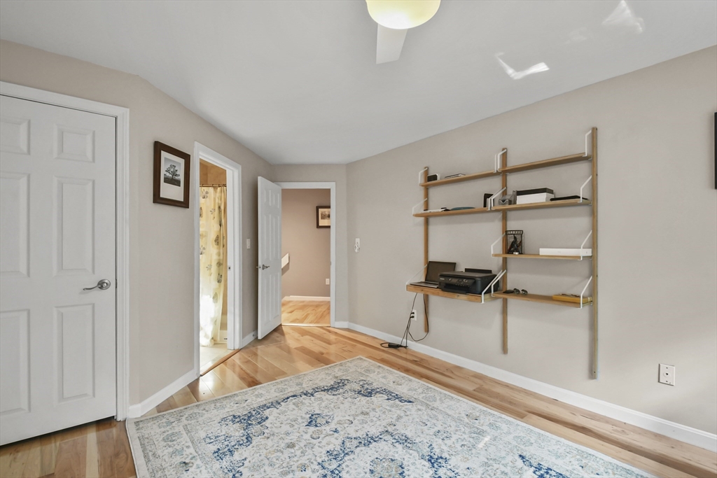 64 Mountain Gate Road, Unit 64 Ashland, MA 01721 - Photo 18 of 31 a bedroom with a bed and a view of living room