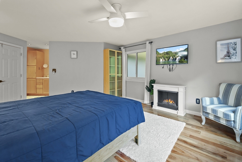 64 Mountain Gate Road, Unit 64 Ashland, MA 01721 - Photo 23 of 31 a bedroom with a bed and a fireplace