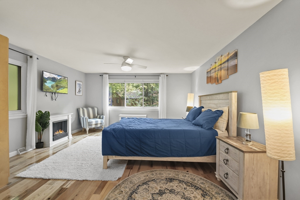64 Mountain Gate Road, Unit 64 Ashland, MA 01721 - Photo 24 of 31 a living room with a bed furniture and a window