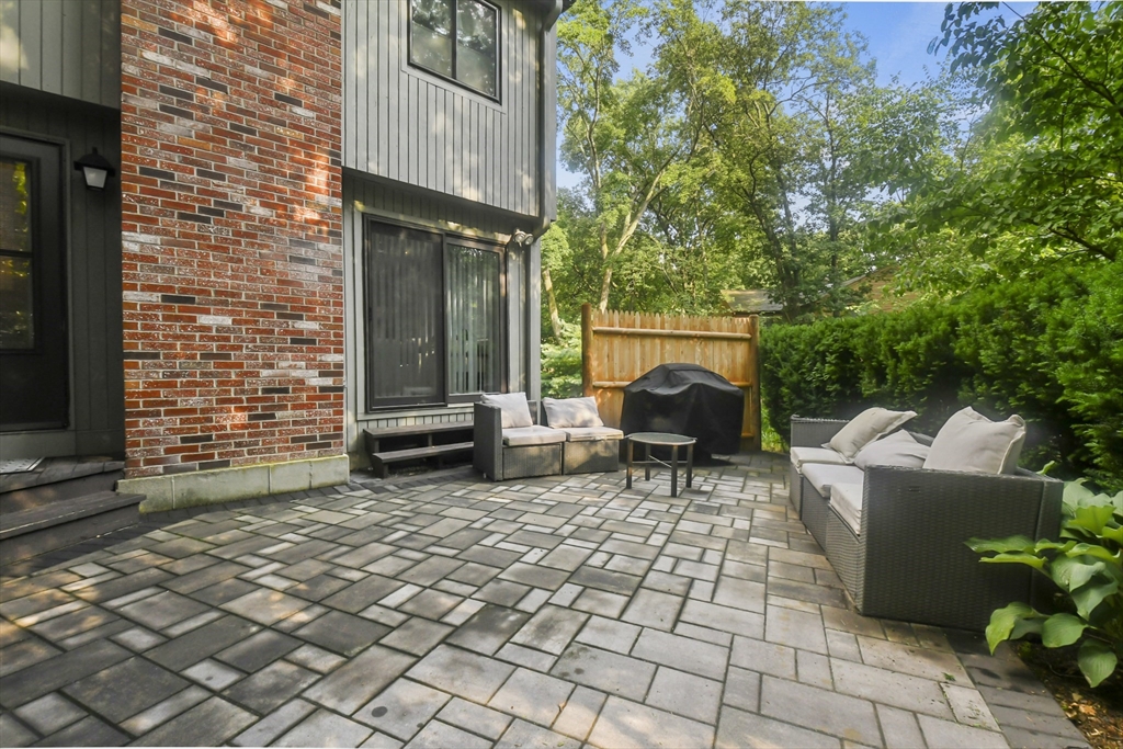 64 Mountain Gate Road, Unit 64 Ashland, MA 01721 - Photo 3 of 31 a backyard of a house with fire pit and outdoor seating