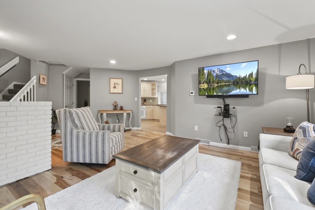64 Mountain Gate Road, Unit 64 Ashland, MA 01721 - Photo 6 of 31 a living room with furniture and a flat screen tv