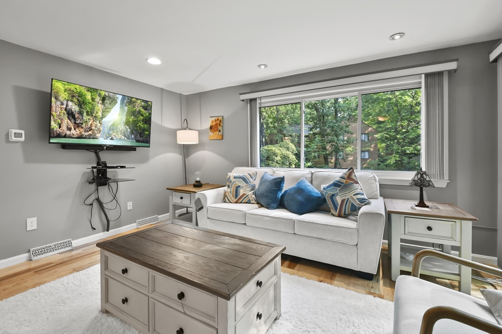64 Mountain Gate Road, Unit 64 Ashland, MA 01721 - Photo 7 of 31 a living room with furniture a large window and a flat screen tv