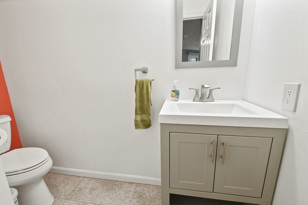 64 Mountain Gate Road, Unit 64 Ashland, MA 01721 - Photo 9 of 31 a bathroom with a sink a toilet and vanity