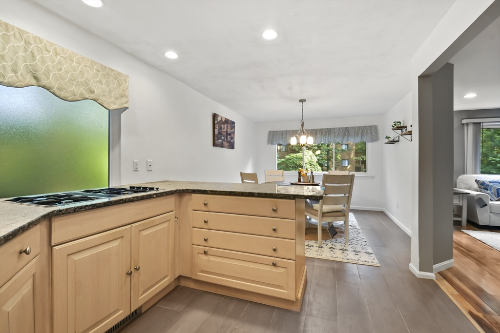 64 Mountain Gate Road, Unit 64 Ashland, MA 01721 - Photo 10 of 31 a kitchen with granite countertop white cabinets and white appliances