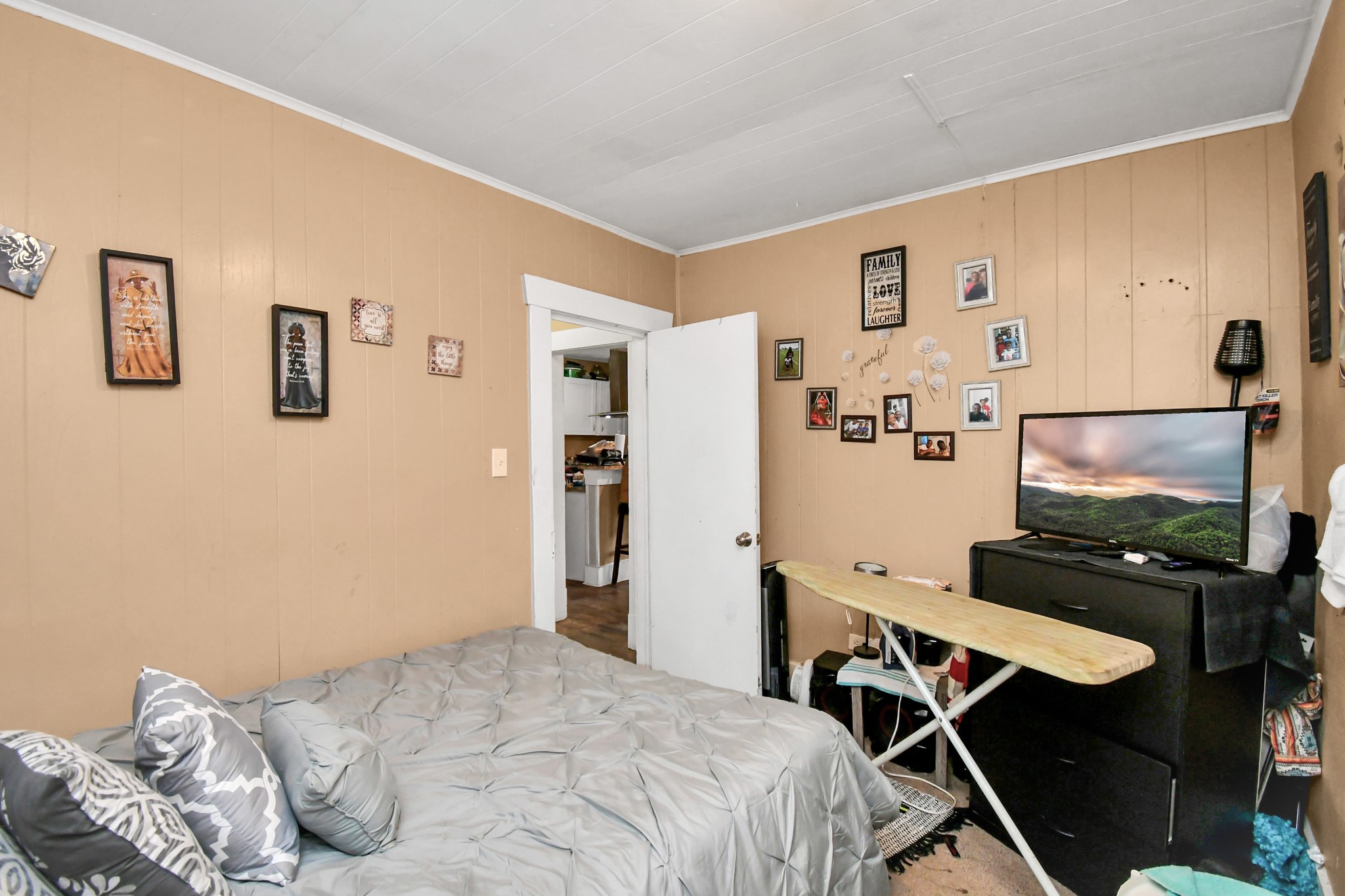 3818 Drew Street Houston, TX 77004 - Photo 22 of 35 a bedroom with furniture and a flat screen tv