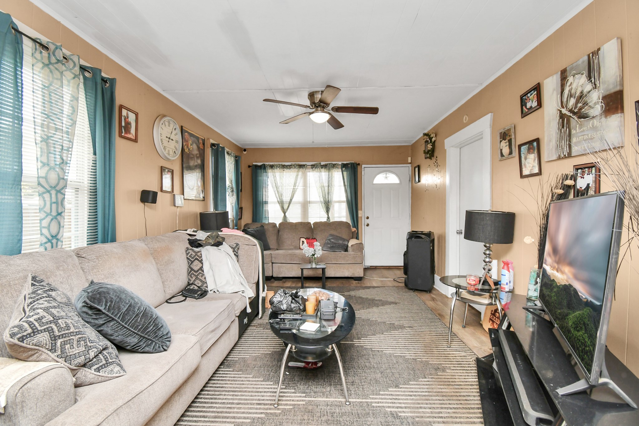3818 Drew Street Houston, TX 77004 - Photo 9 of 35 a living room with furniture a flat screen tv and a large window