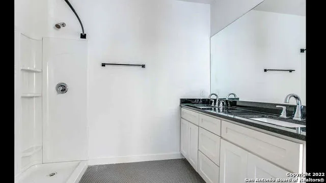 a kitchen with stainless steel appliances granite countertop white cabinets and white appliances
