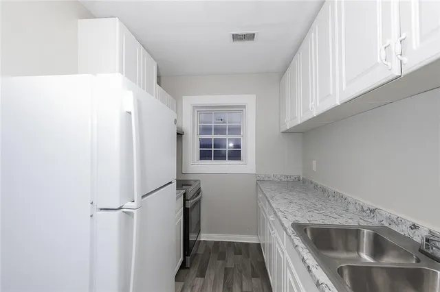 a kitchen with a refrigerator and a sink
