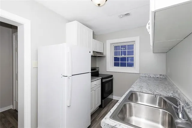 a kitchen with a refrigerator and a sink