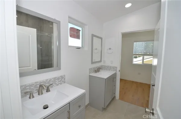 a bathroom with a sink mirror and vanity