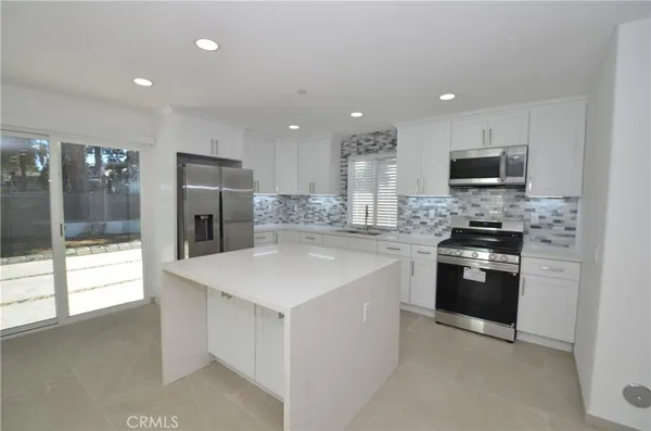 a kitchen with a sink stove and refrigerator