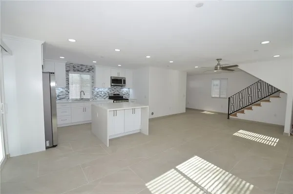 a view of kitchen with stainless steel appliances refrigerator oven and cabinets