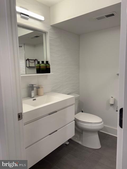 2006 Cambridge Street, Unit A Philadelphia, PA 19130 - Photo 11 of 17 a bathroom with a toilet sink and mirror