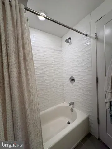 a bathroom with a bathtub and shower