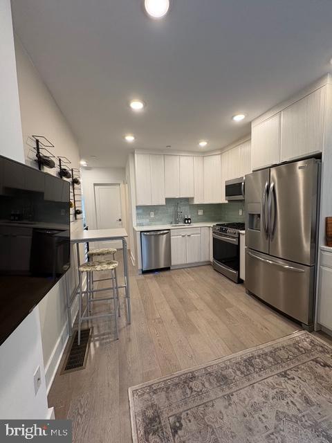 2006 Cambridge Street, Unit A Philadelphia, PA 19130 - Photo 3 of 17 a kitchen with stainless steel appliances granite countertop a refrigerator a stove a sink a microwave and a refrigerator