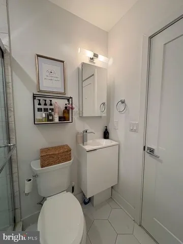 a white toilet sitting next to a bathroom sink